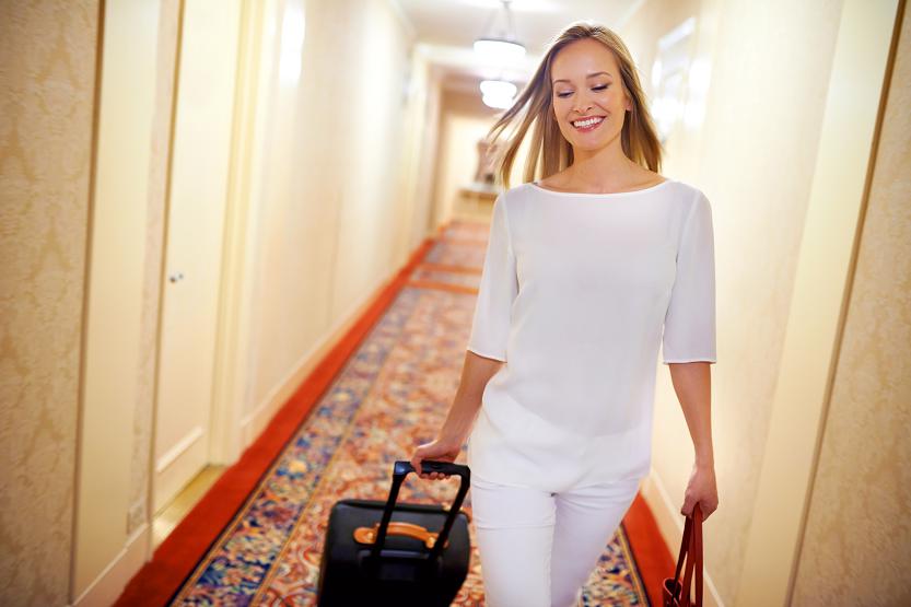 She stays at the finest hotels. Shot of an attractive young woman arriving at her hotel suite
